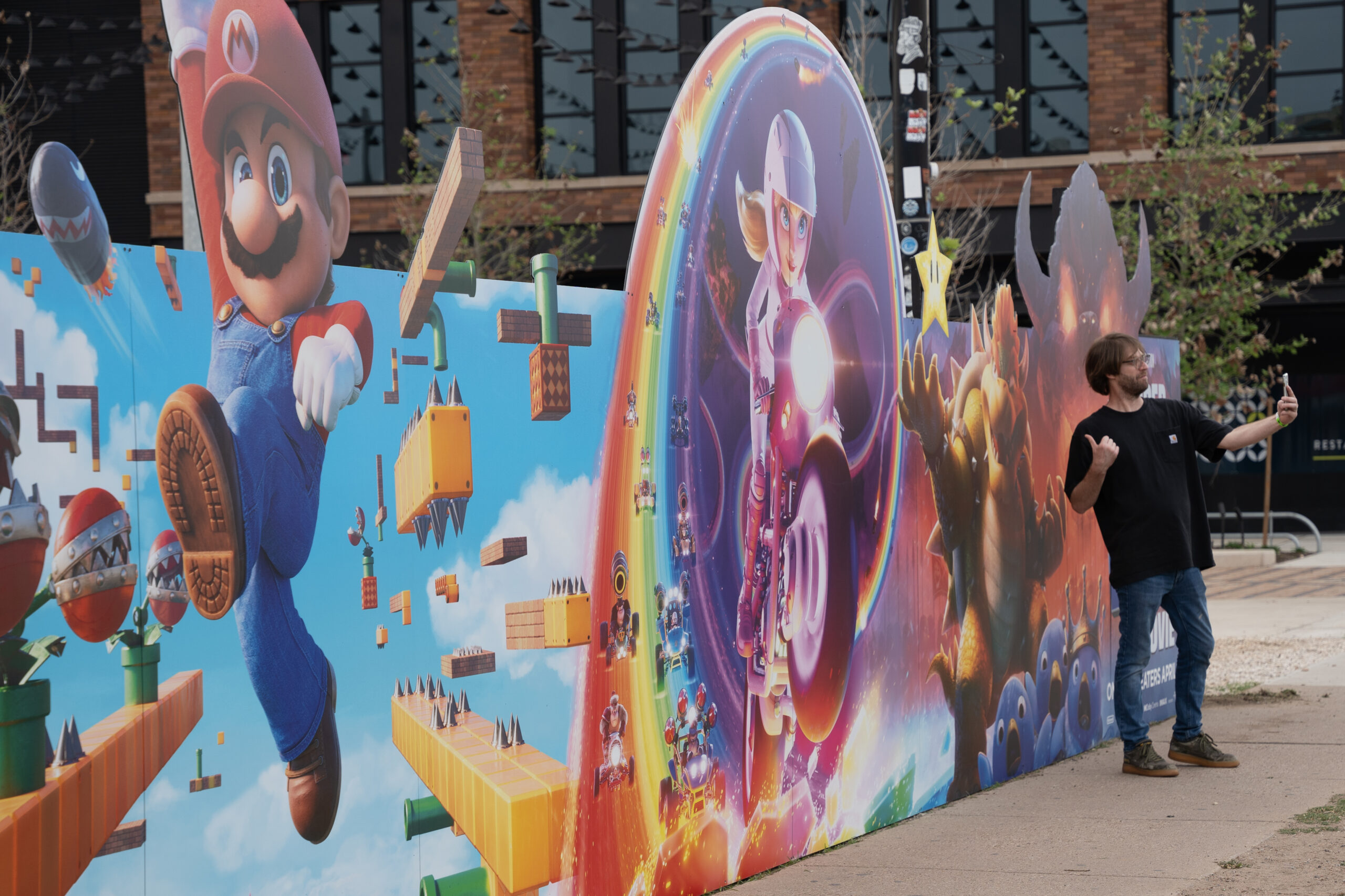 Super Mario Bros. POP Mural Left-Angle Close-Up Man Taking Selfie Austin Street-Level Billboard