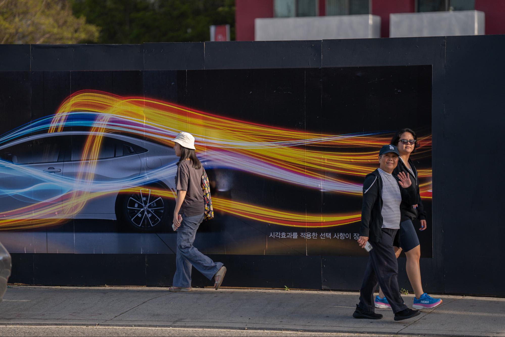 Toyota Prius Aerodynamics Graphic Barricade Woman Waving LA Koreatown Out-of-Home Advertising
